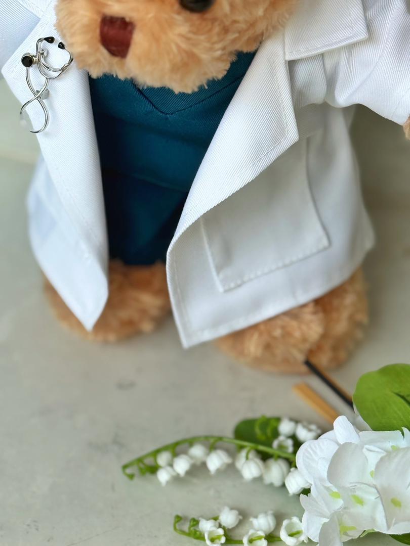 Doctor Bear — A handcrafted teddy bear in a white doctor's coat, teal scrubs, and a miniature stethoscope. Personalised with your recipient's name — the ultimate meaningful gift for a medical graduate.